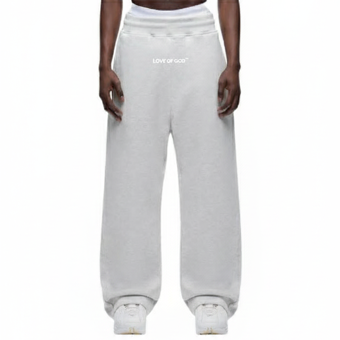 White sweatpants worn by a person on a white background